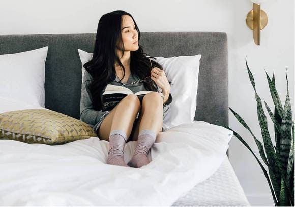 Lady reading in a Leesa bed